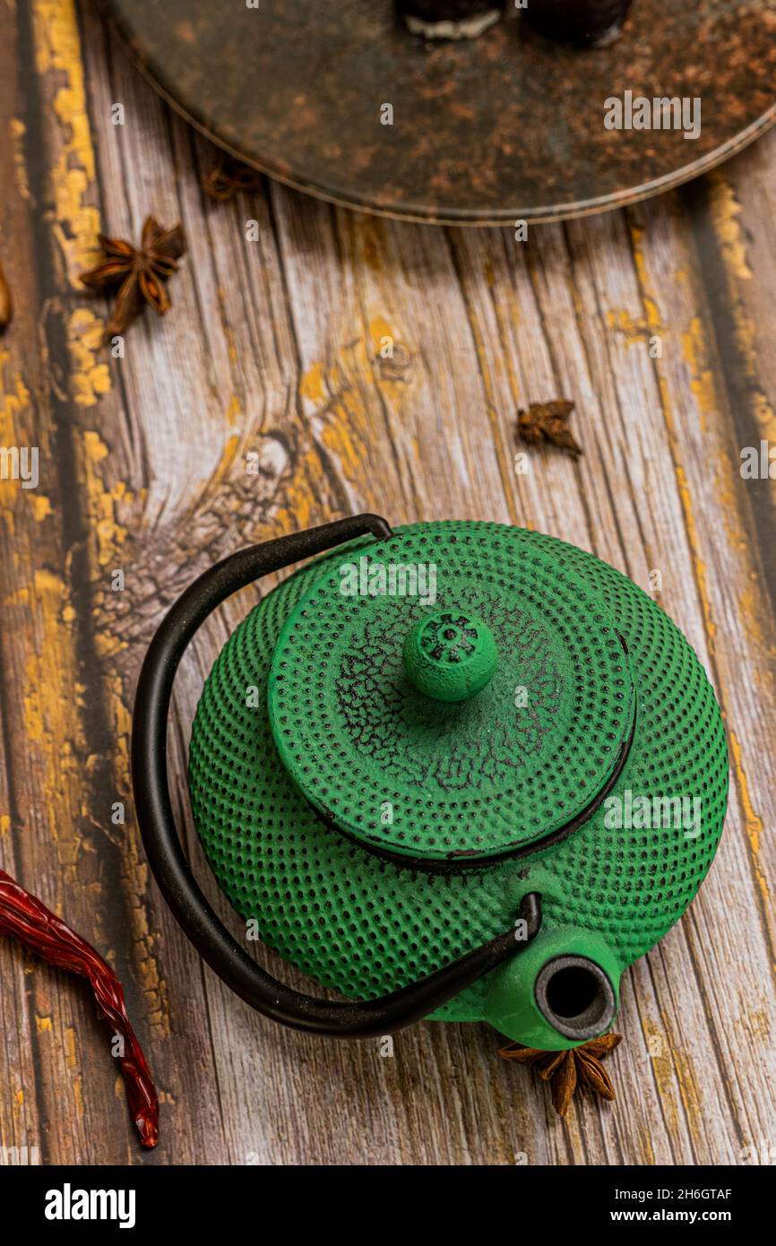 traditional green wrought iron teapot to serve tea in asia Stock Photo