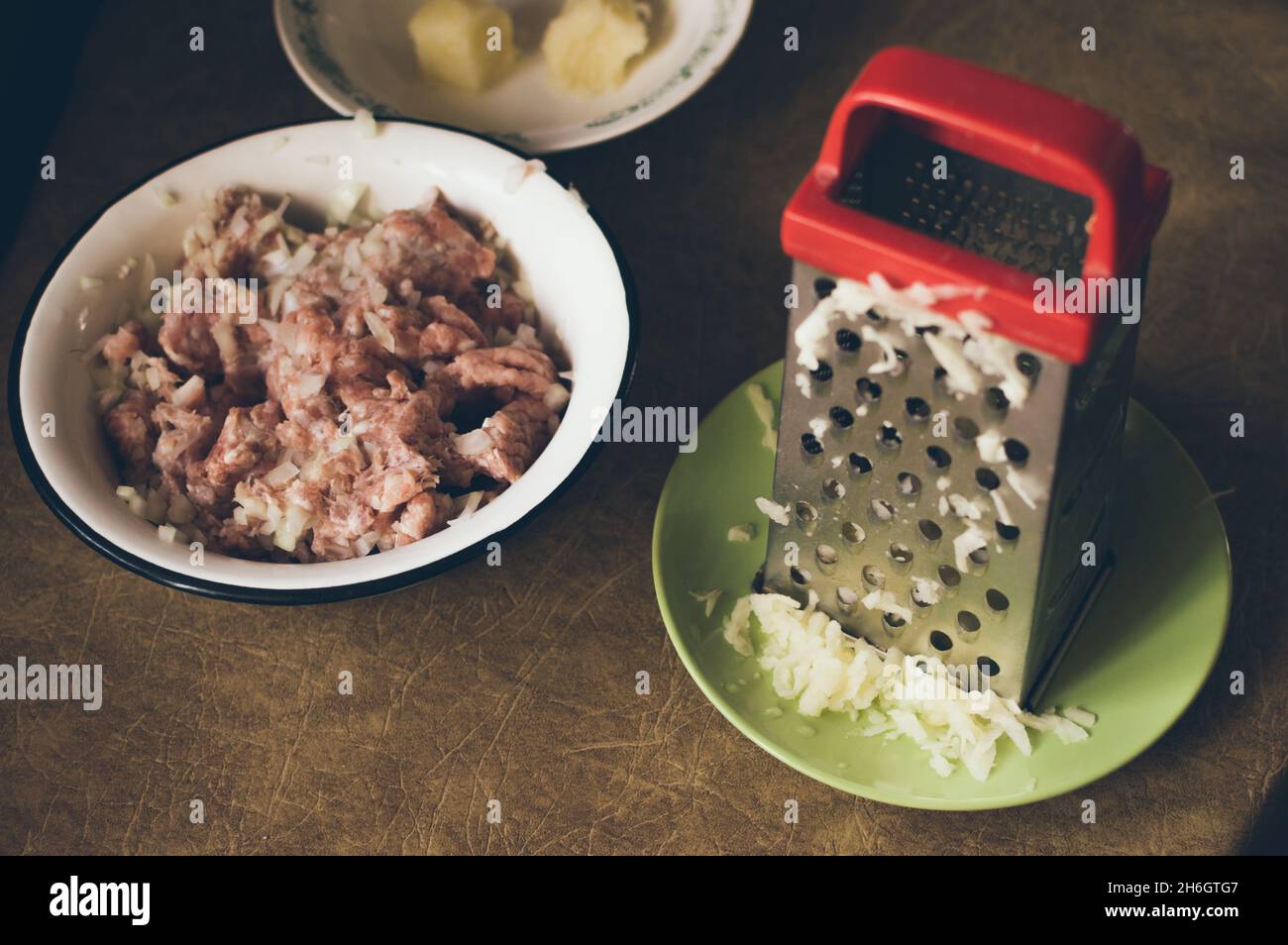 https://c8.alamy.com/comp/2H6GTG7/cooking-minced-meat-grating-potatoes-on-a-grater-2H6GTG7.jpg