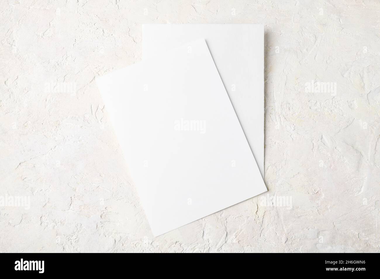 Two white invitation card mockup on light stone background, minimalist mockup 5x7 ratio, similar to A6, A5 Stock Photo