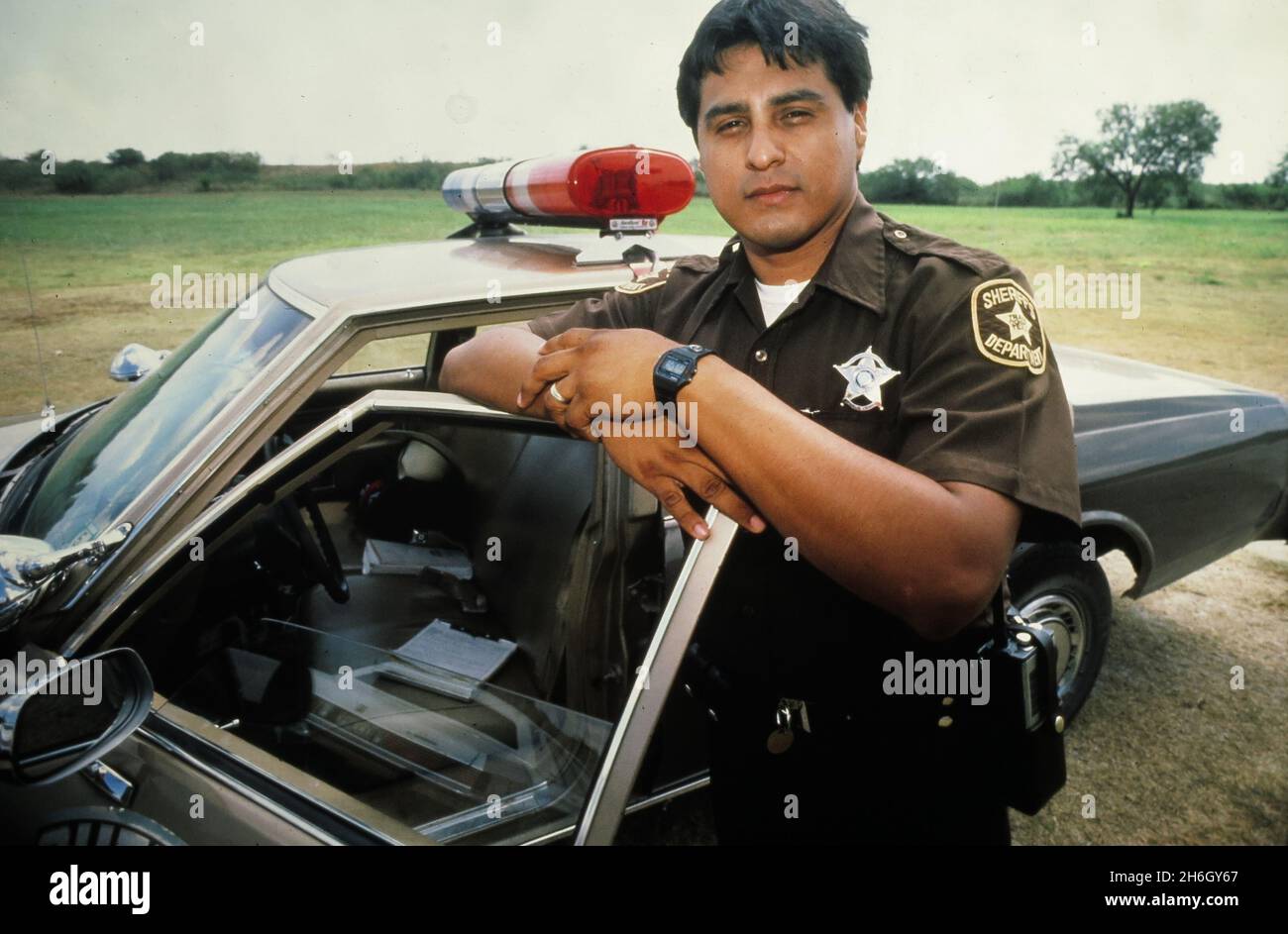 Austin Texas USA, circa 1987: Hispanic police officer working for the Travis County Sheriff's Office. ©Bob Daemmrich Stock Photo
