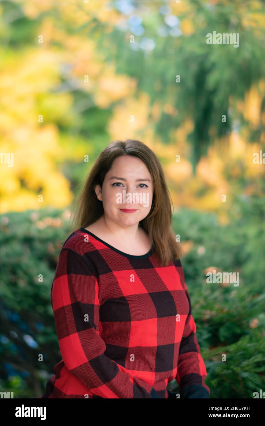 Pretty woman with a colorful autumn background Stock Photo