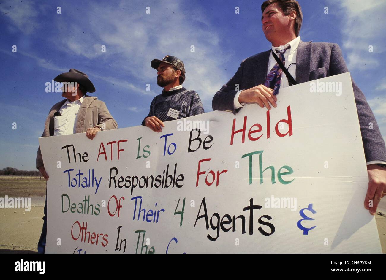 Waco Texas USA, 1993: Protesters in Waco, Texas outside the Branch Davidian siege checkpoint to the cult compound hold a sign placing blame on the federal Alcohol, Tobacco and Firearms (ATF) agency.  ©Bob Daemmrich Stock Photo