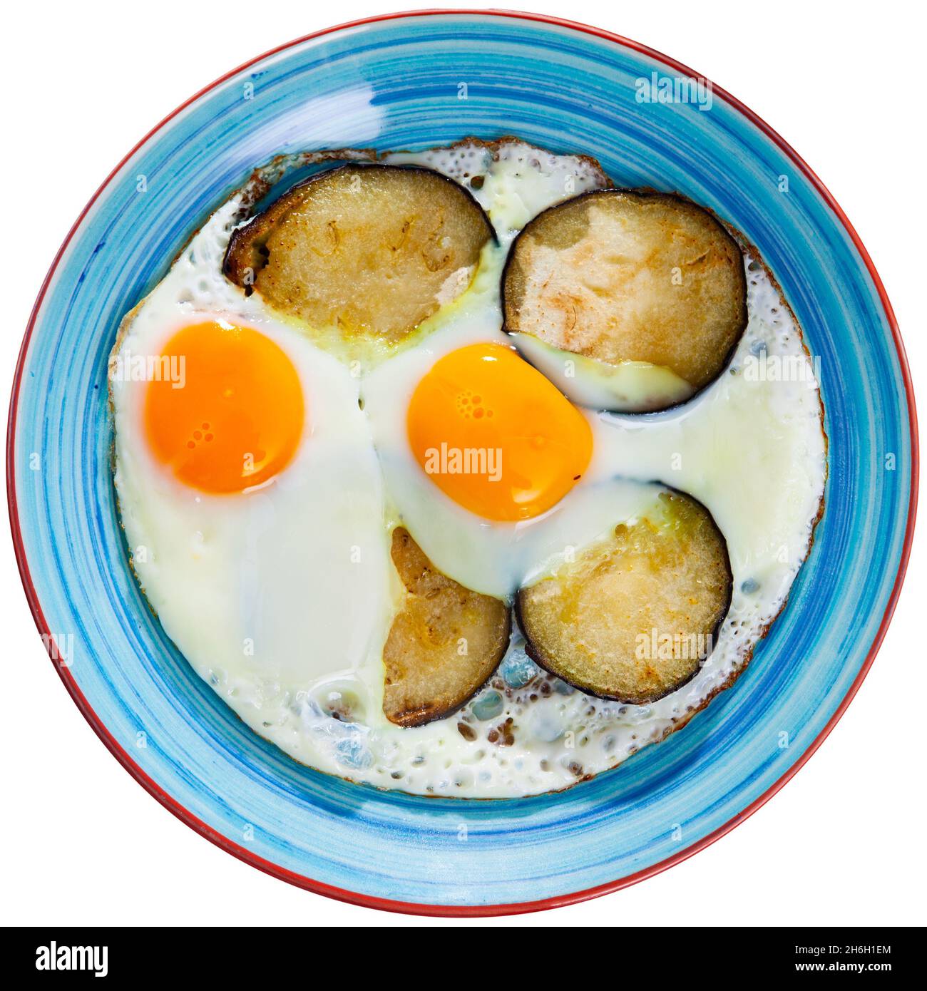 Delicious breakfast scrambled eggs with fried eggplant closeup Stock