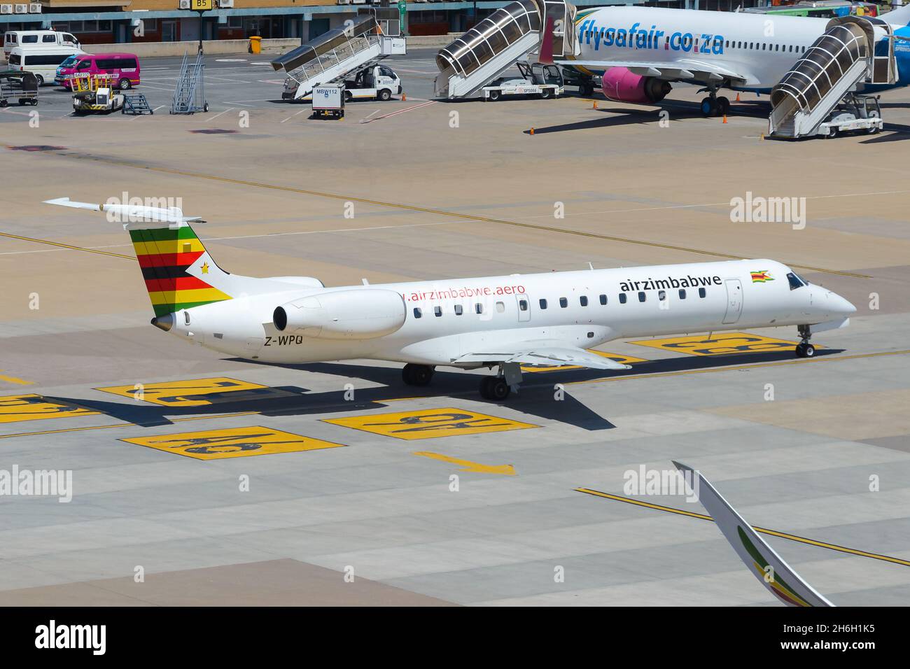 Air Zimbabwe new Embraer 145 airplane at Johannesburg Airport, South Africa. Regional aircraft of AirZimbabwe. Stock Photo