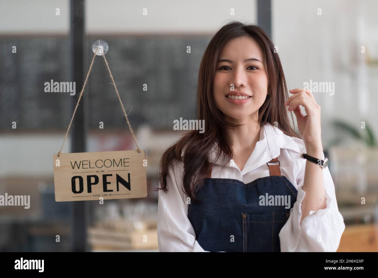 Portrait of Startup successful small business owner in coffee shop.handsome woman barista cafe owner. SME entrepreneur seller business concept Stock Photo