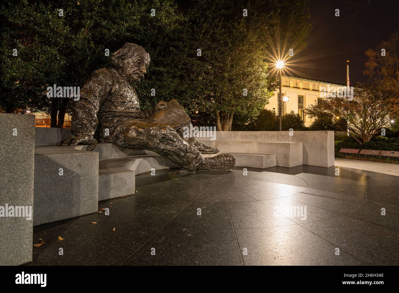 Washington DC—Nov 25th, 2021; bronze statue of Albert Einstein sits in front of the National Academy of Science in National capital at night Stock Photo