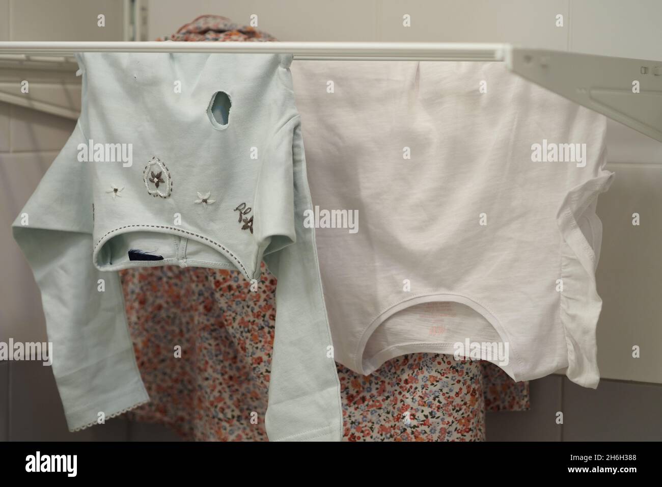 Clothes hanging on the dryer, baby clothes Stock Photo Alamy