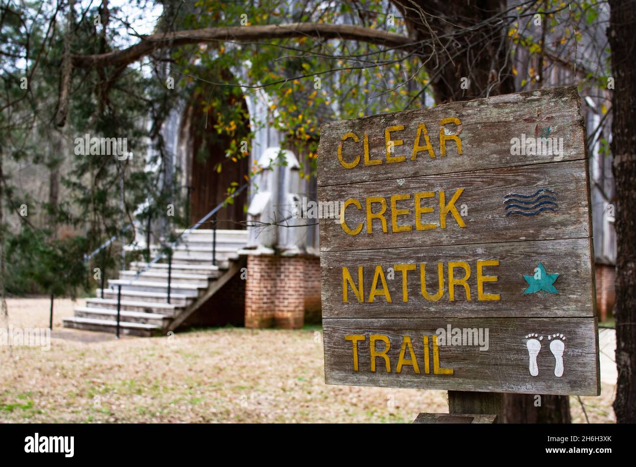 Orrville, Alabama, USA - Jan. 26, 2021: Sign for Clear Creek Nature Trail with St. Luke's Episcopal Church in the background at Old Cahawba Archaeolog Stock Photo