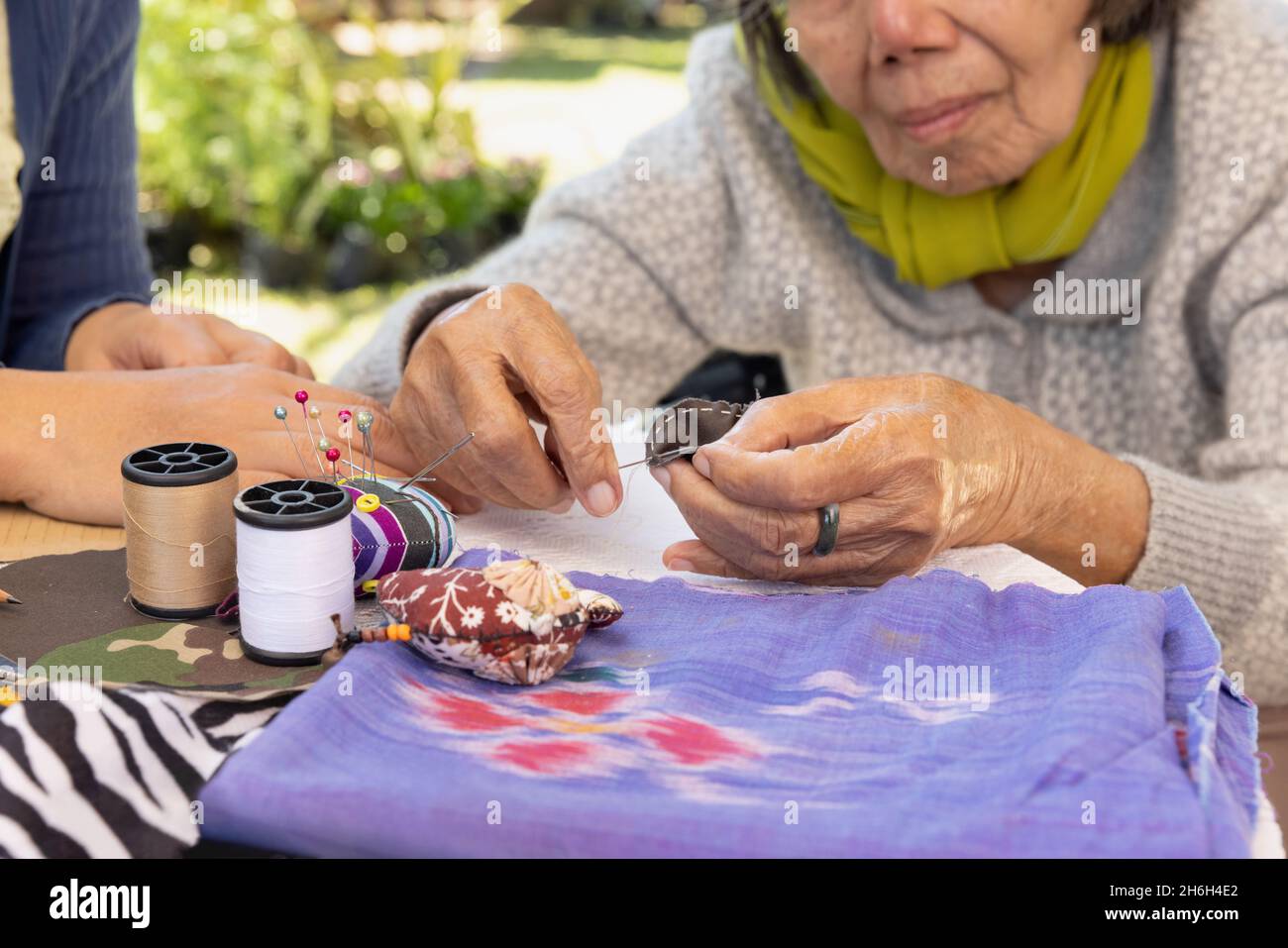Elderly woman and daughter in the needle crafts occupational therapy for Alzheimer’s or dementia Stock Photo