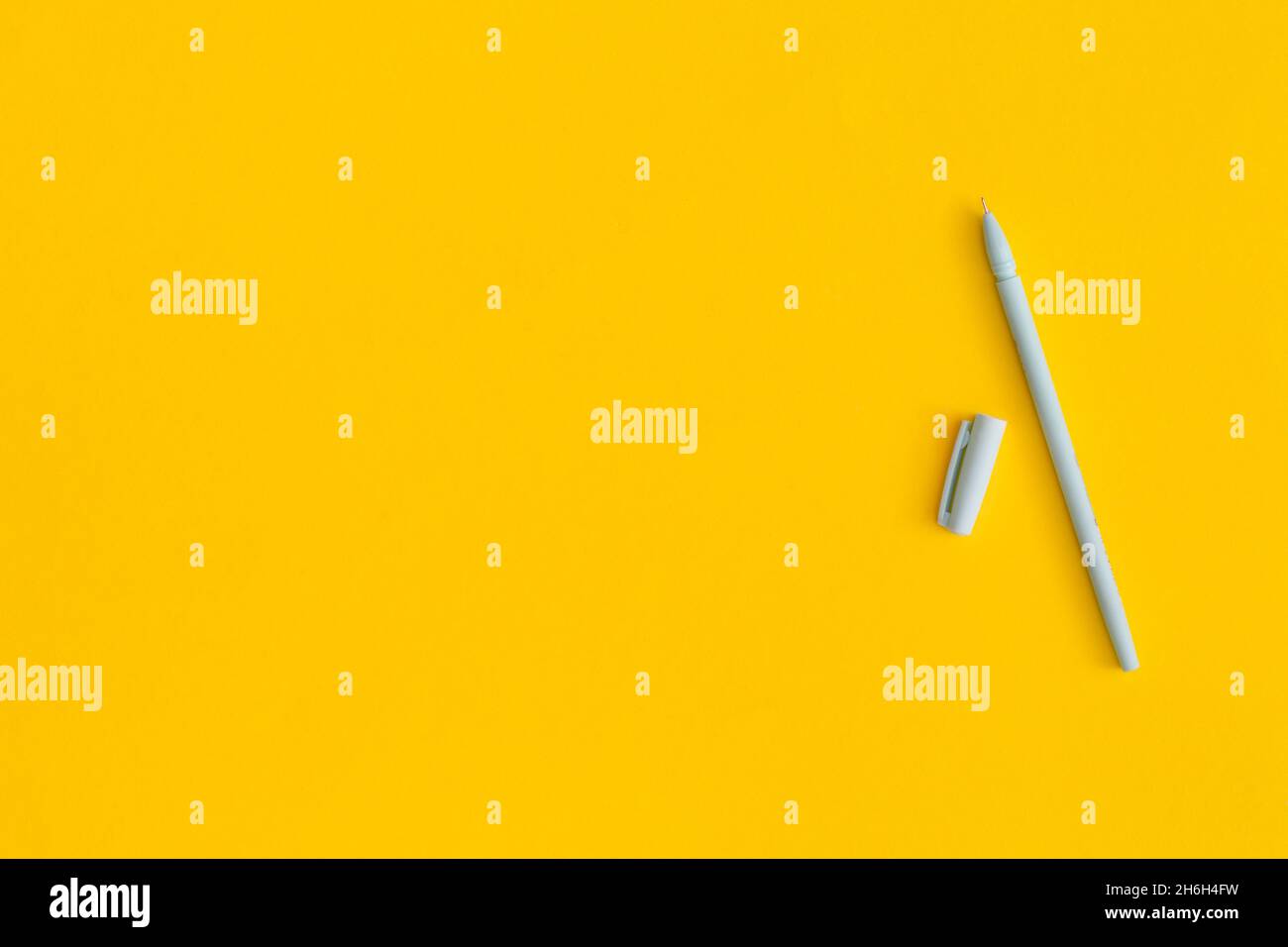 Pen on yellow background with space for text Stock Photo