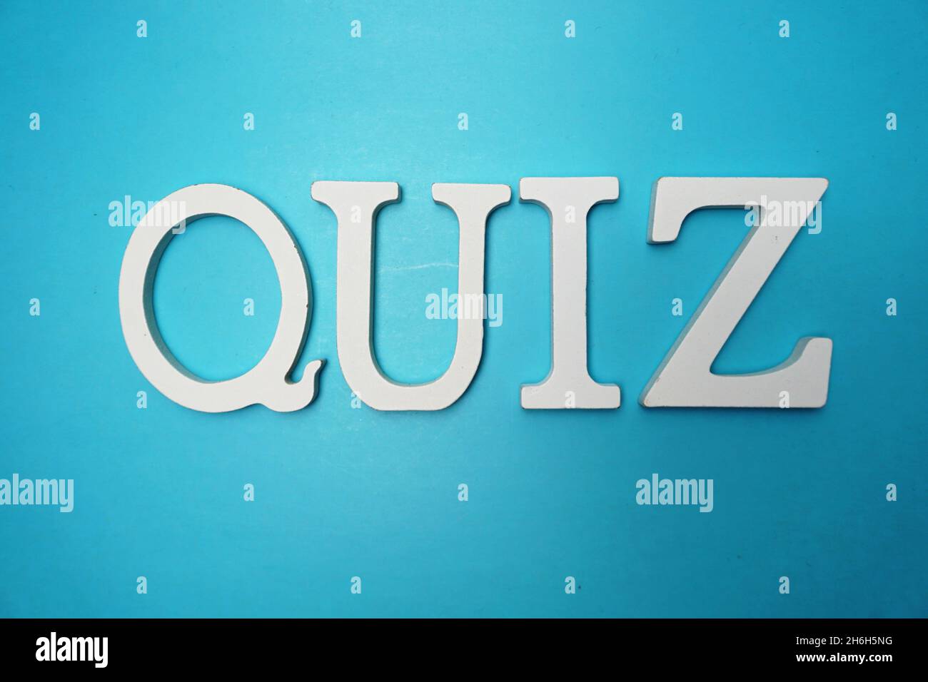 Top view Quiz letters alphabet letters on blue background Stock Photo ...