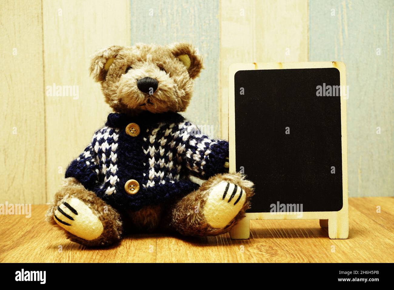 Teddy bear and blackboard easel wooden space background Stock Photo - Alamy