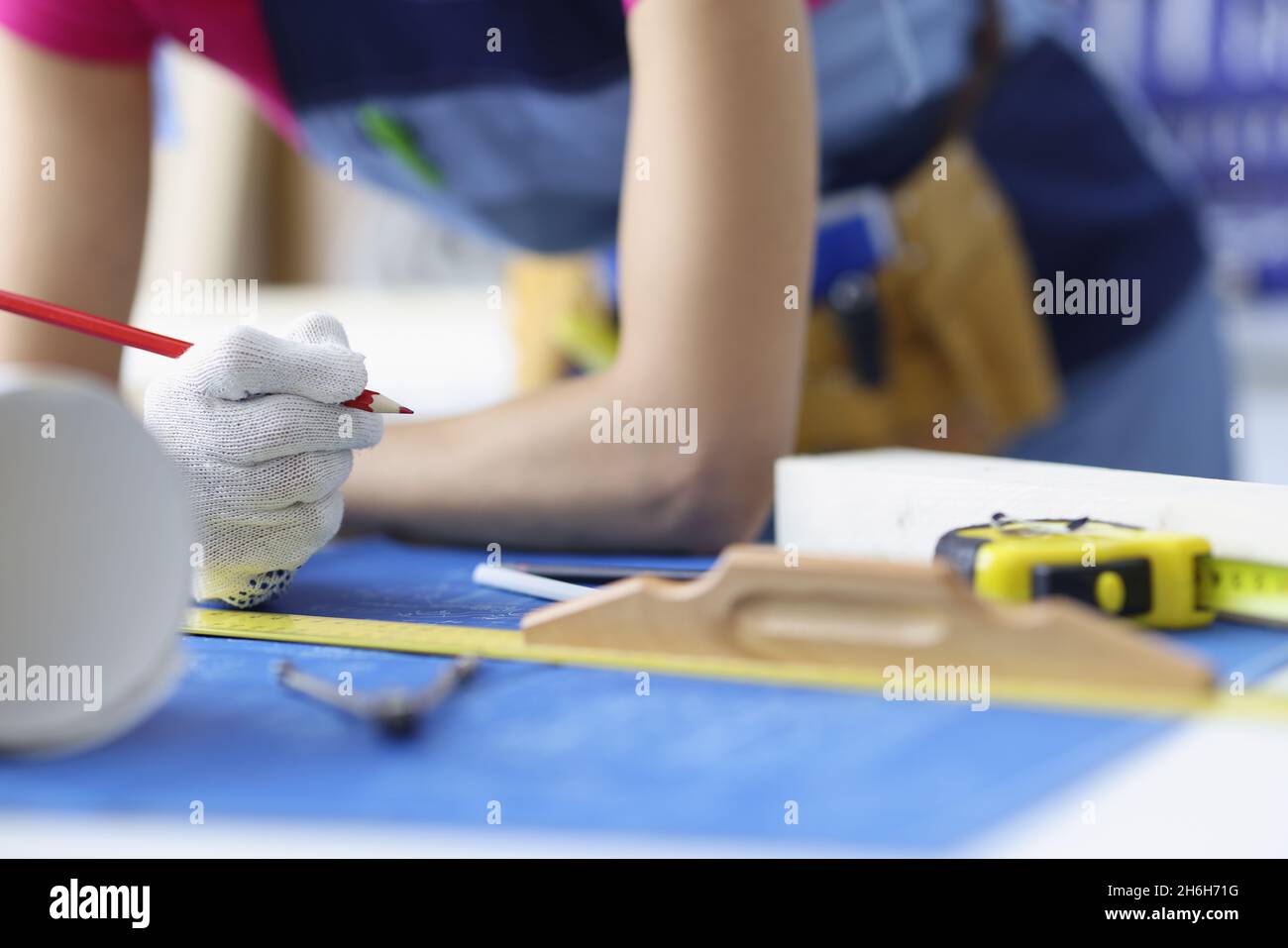 Woman worker making corrections in construction planning with pencil Stock Photo