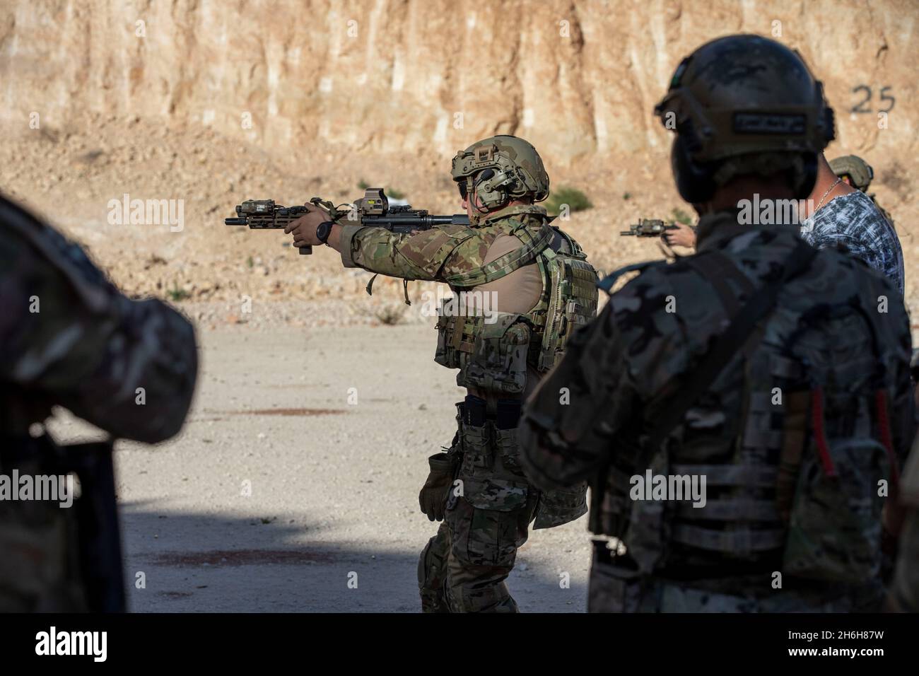 A 5th Special Forces Group soldier demonstrates the proper technique for a combat marksmanship drill during a Joint Combined Exchange Training (JCET) at the Zarqu Training Area, Jordan, Nov. 9, 2021. The multi-week JCET conducted with the Jordanian 1st Company, 101st Special Forces Brigade will cover different shooting tactics and medical training in order to build confidence working alongside partner forces for future counter Daesh operations. Stock Photo
