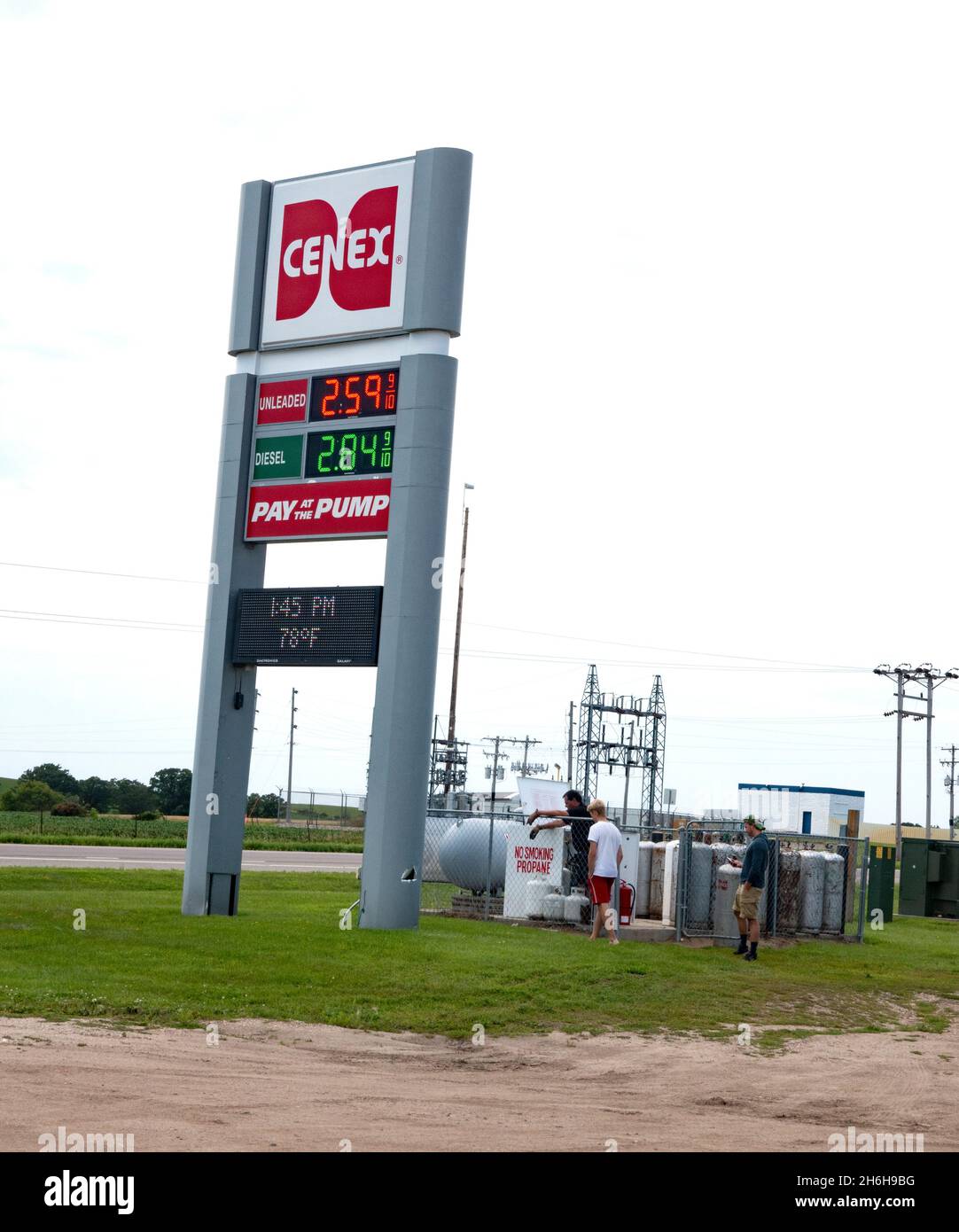 Men at a Cenex gas station exchanging and filling propane tanks. Clitherall Minnesota MN USA Stock Photo