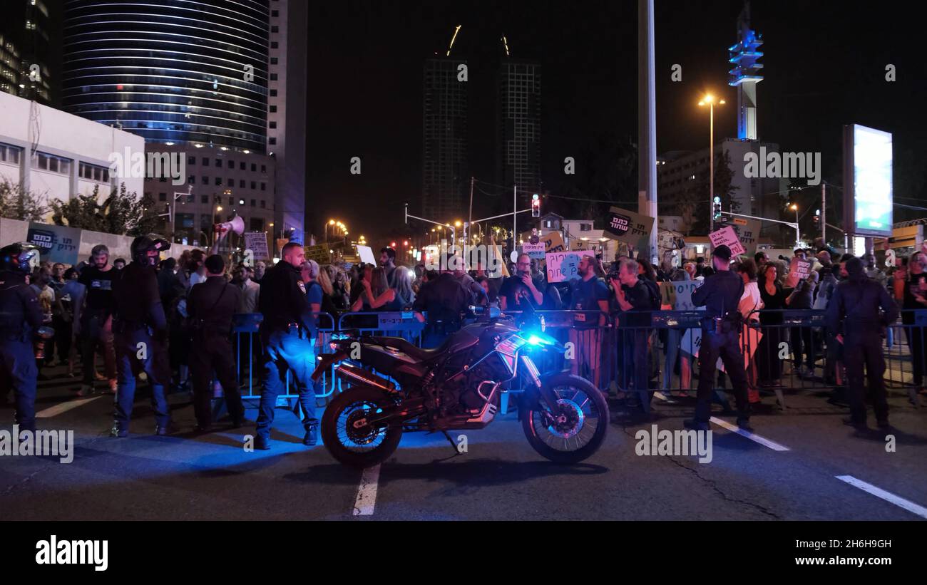 Police watch over as anti-vax protesters demonstrate against forced Covid vaccination and Green Pass rules on November 13, 2021 in Tel Aviv, Israel. A panel of medical experts at Israel’s Health Ministry recently voted in favor of a COVID vaccine for kids in a secret ballot. Stock Photo