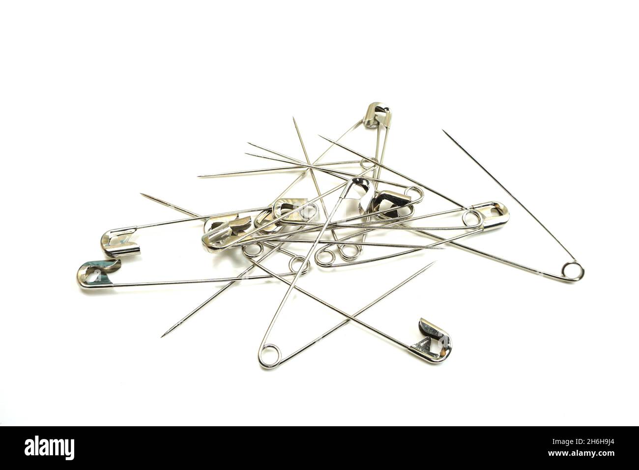 metal safety pins isolated on white background Stock Photo - Alamy