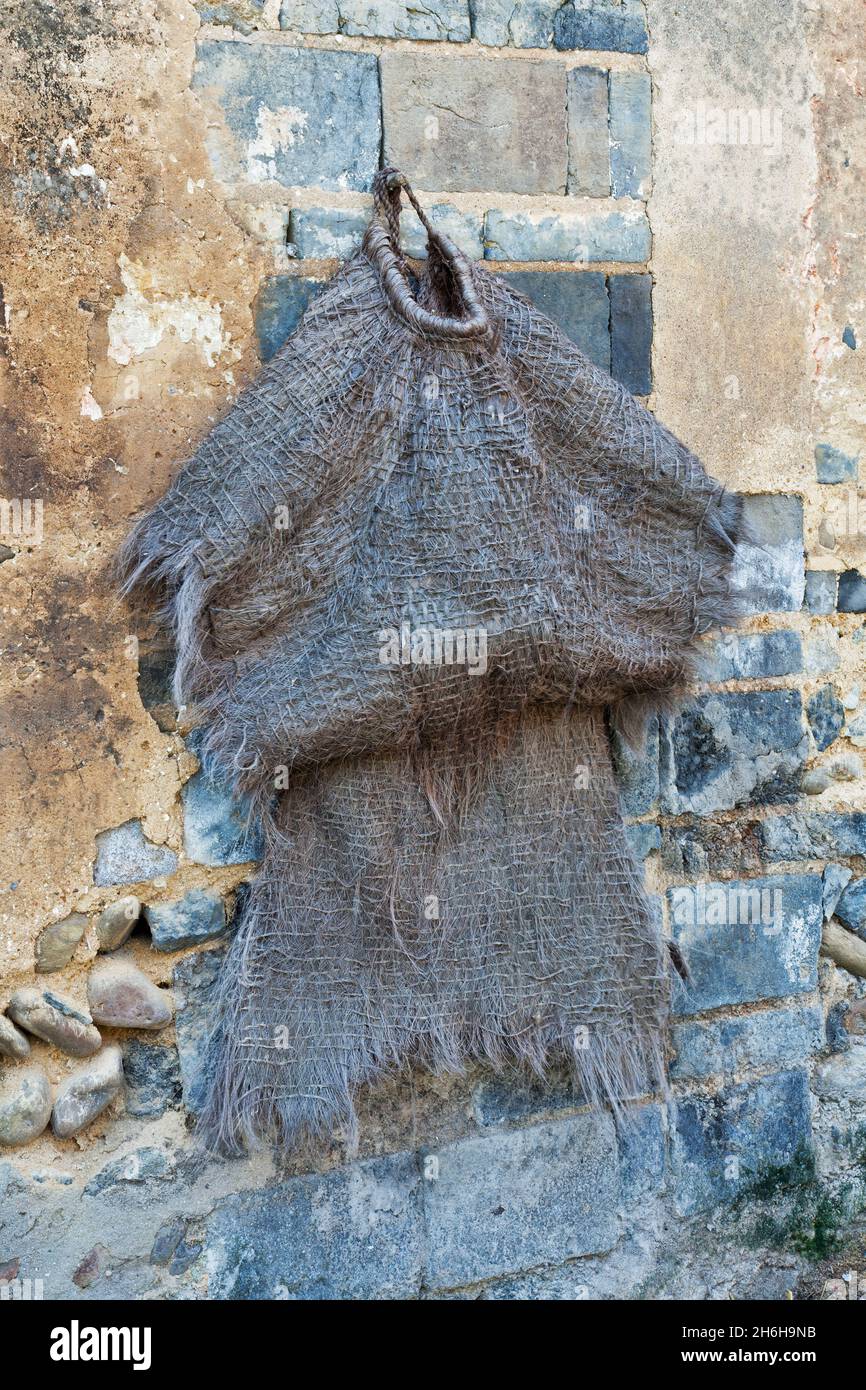 An old raincoat hangs outside a home in Duxu. Daxu Ancient Town was formed at the beginning of the Song dynasty. A 2.3km long and 2m wide stone street Stock Photo