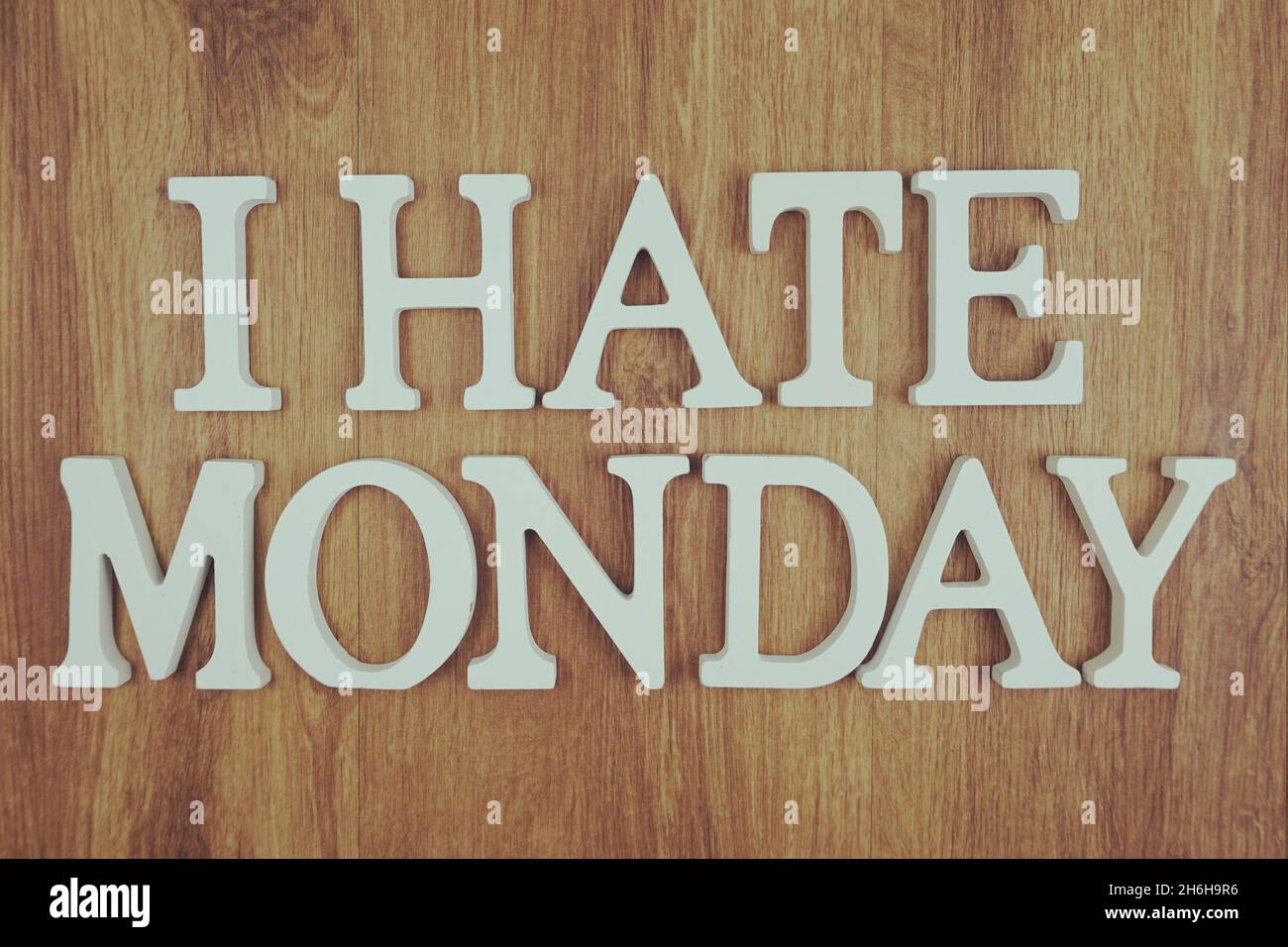 I Hate Monday alphabet letters top view on wooden background Stock Photo