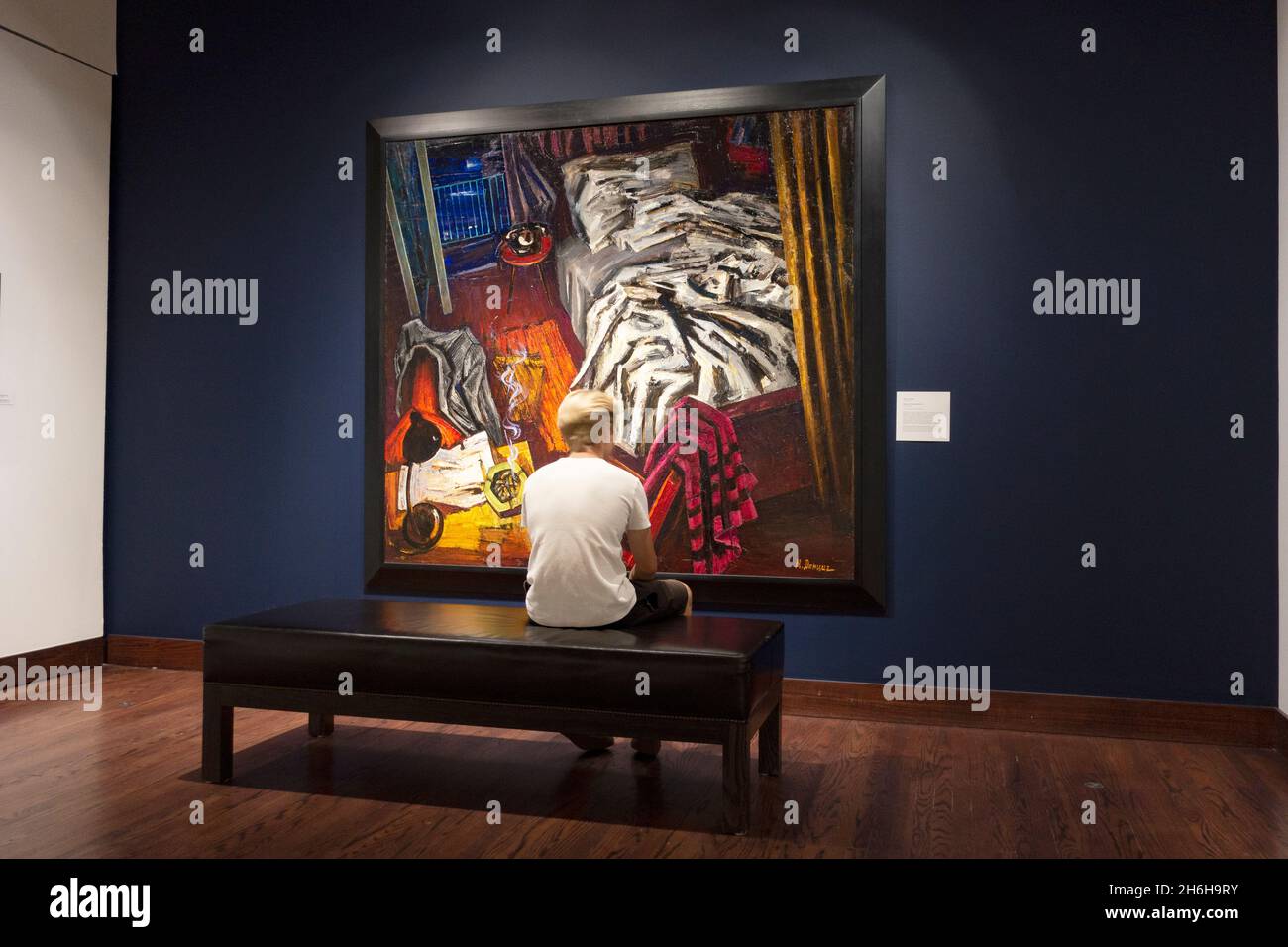 Teenage boy sitting and thoughtfully studying a painting at the Museum of Russian Art. Minneapolis Minnesota MN USA Stock Photo