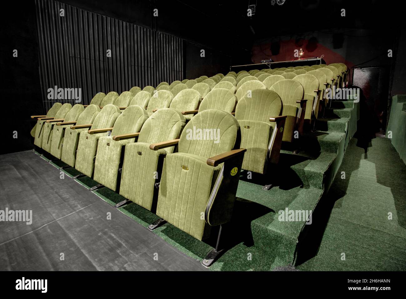 Image of a small auditorium with green armchairs Stock Photo