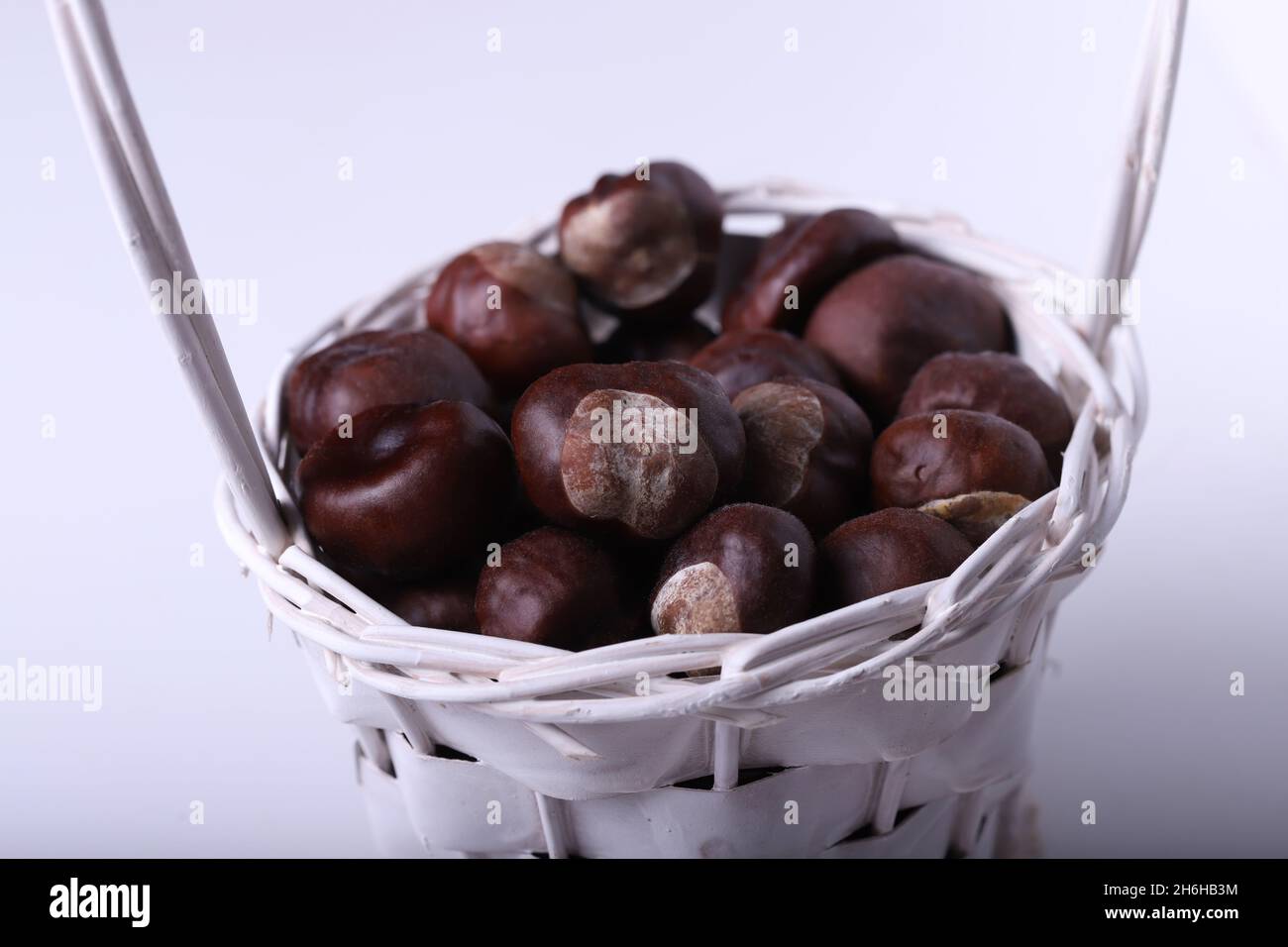 Chestnuts in the basket, white background Stock Photo