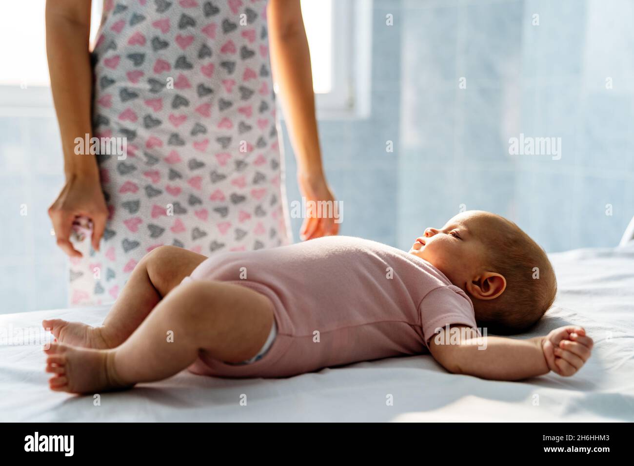 Mother with baby keeps a distance because of postpartum depression. Mental disorder, tiredness Stock Photo