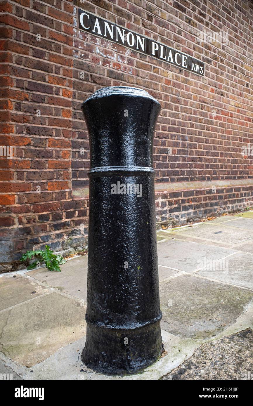 Authentic 18th or early 19th century naval ship cannon used as a bollard at Cannon Place in Hampstead, London, England Stock Photo