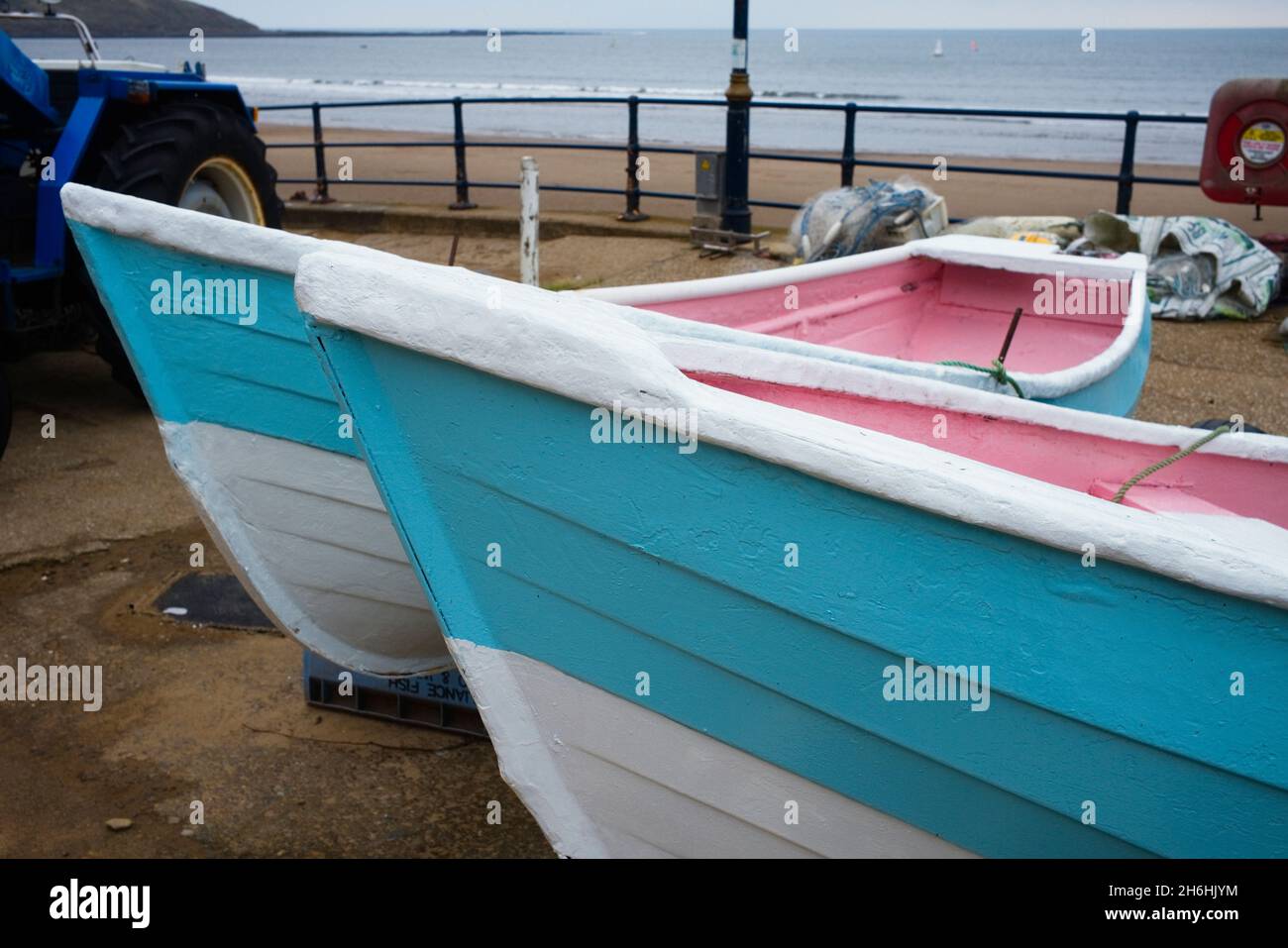 Pink and blue boats on the beachside at Filey in North Yorkshire Stock Photo