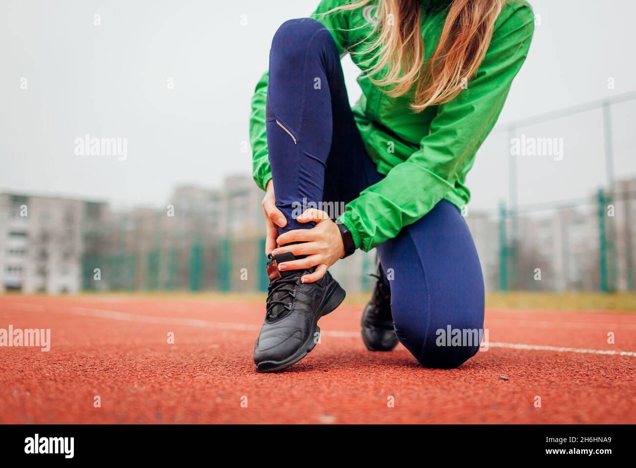 Runner injured leg during intense training on running track on fall