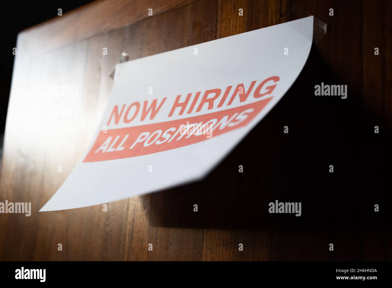Now hiring sign on the wall Stock Photo