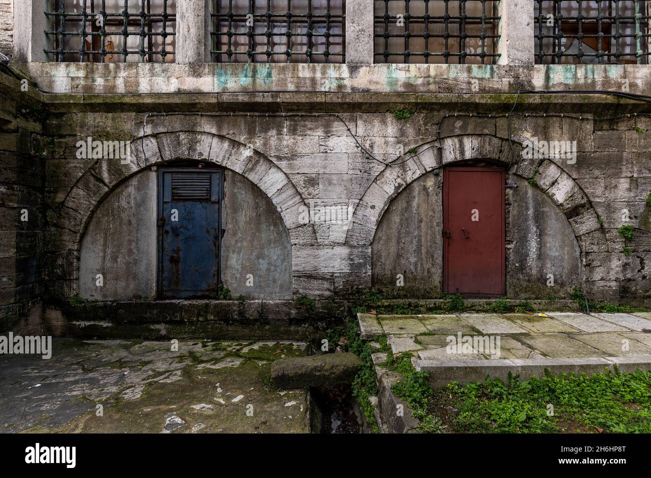 Dirty and worn stone wall and arch gate of a mosque in Istanbul Stock Photo