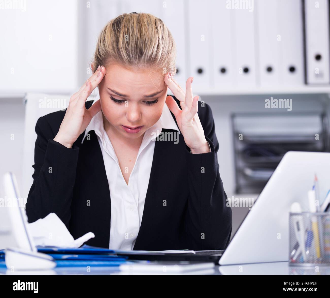 Frustrated business woman with papers Stock Photo