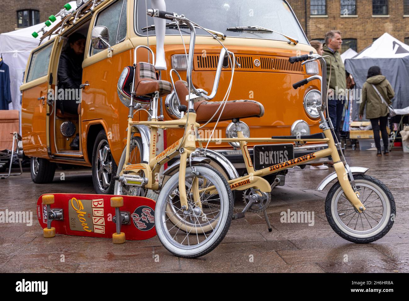 Raleigh cycles and skateboard in front of a classic VW campervan   at the London Classic Car Boot Sale, King's Cross, London, UK Stock Photo