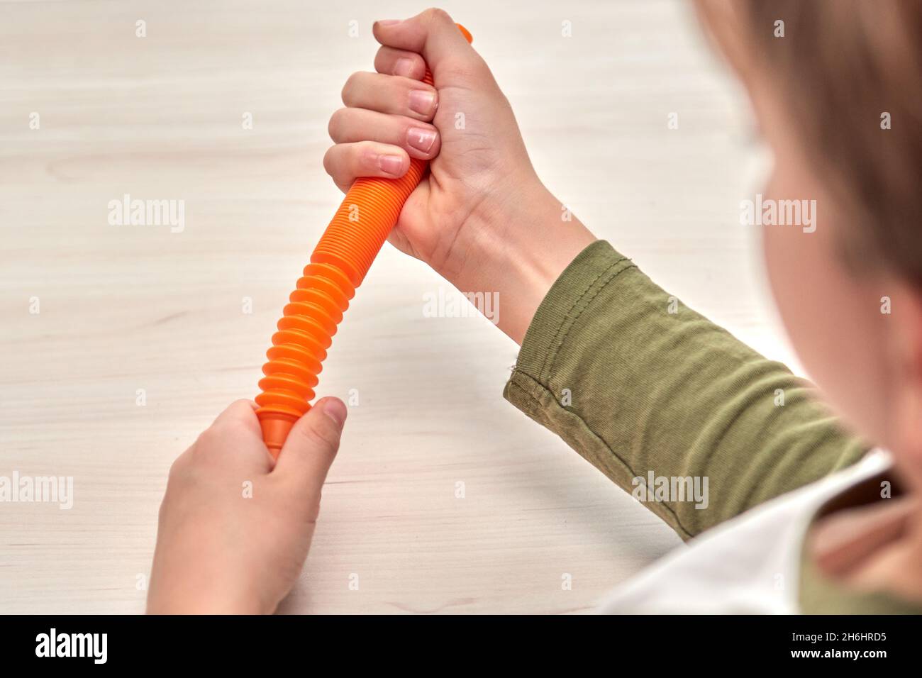 Kids hands push sensory pop tube. Colorfull antistress toys, pop it, simple  dimple. Rainbow silicone sensory fidget New popular trendy silicone toy  Stock Photo - Alamy