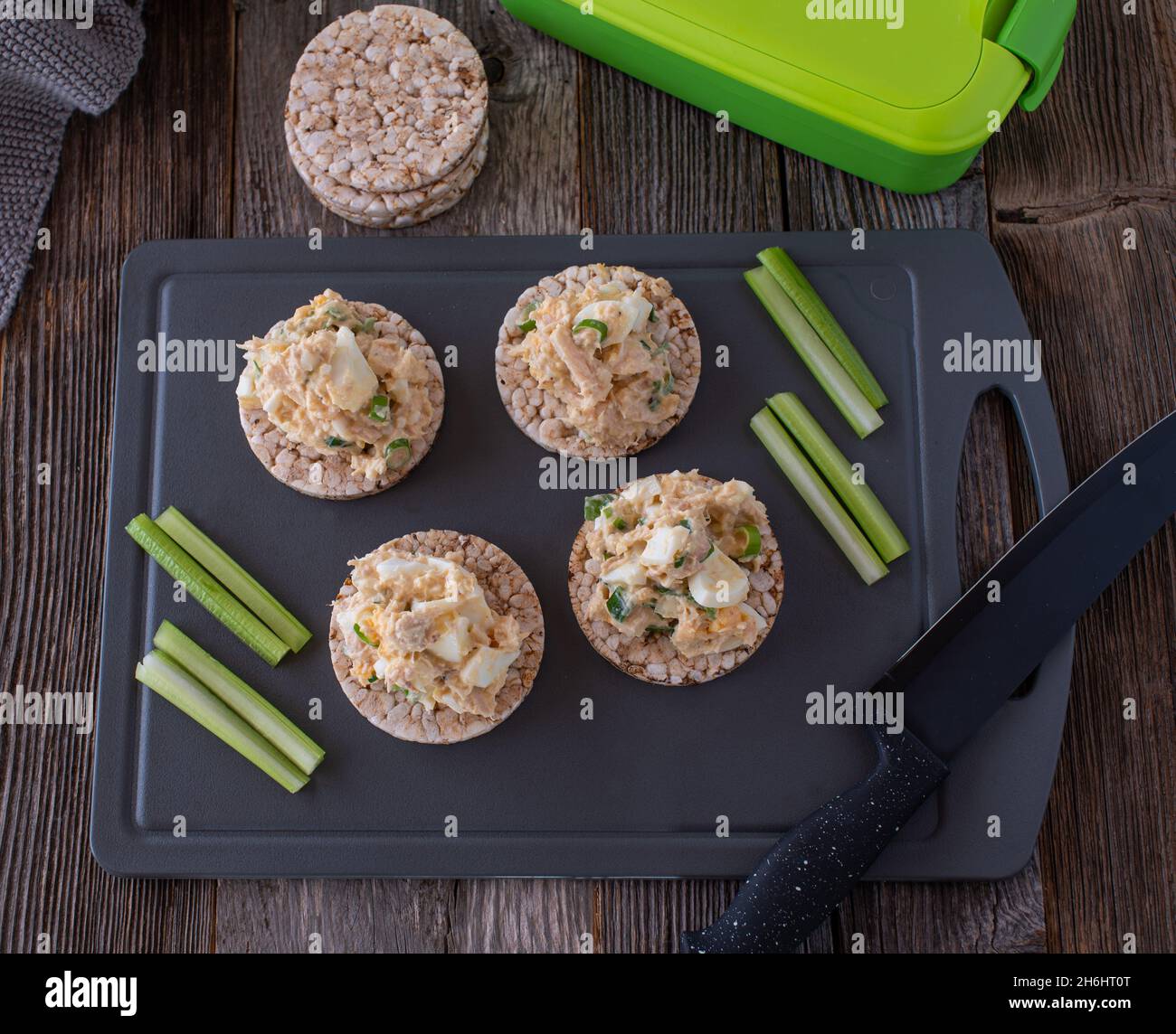 Prep meal for fitness or body building with a high protein and low fat tuna salad served with brown rice crackers and fresh celery sticks Stock Photo