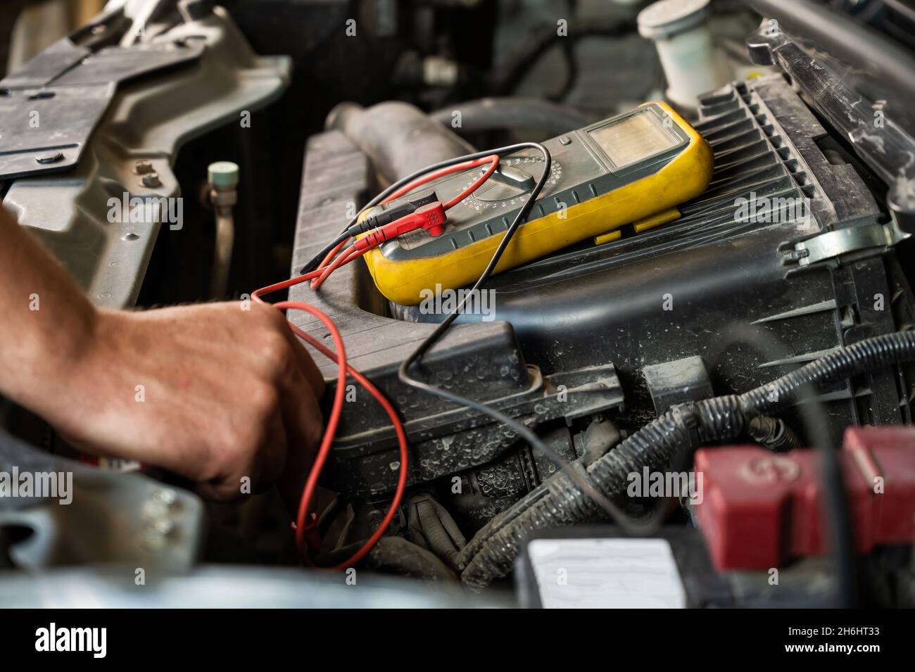Auto mechanic measures voltage with multimeter Stock Photo Alamy