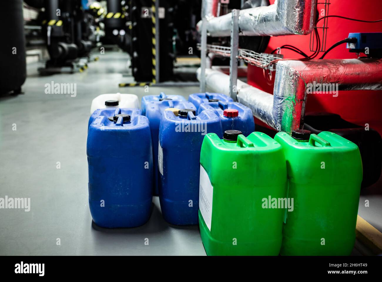 Barrels with chemicals in a chemical warehouse, colored containers Stock Photo