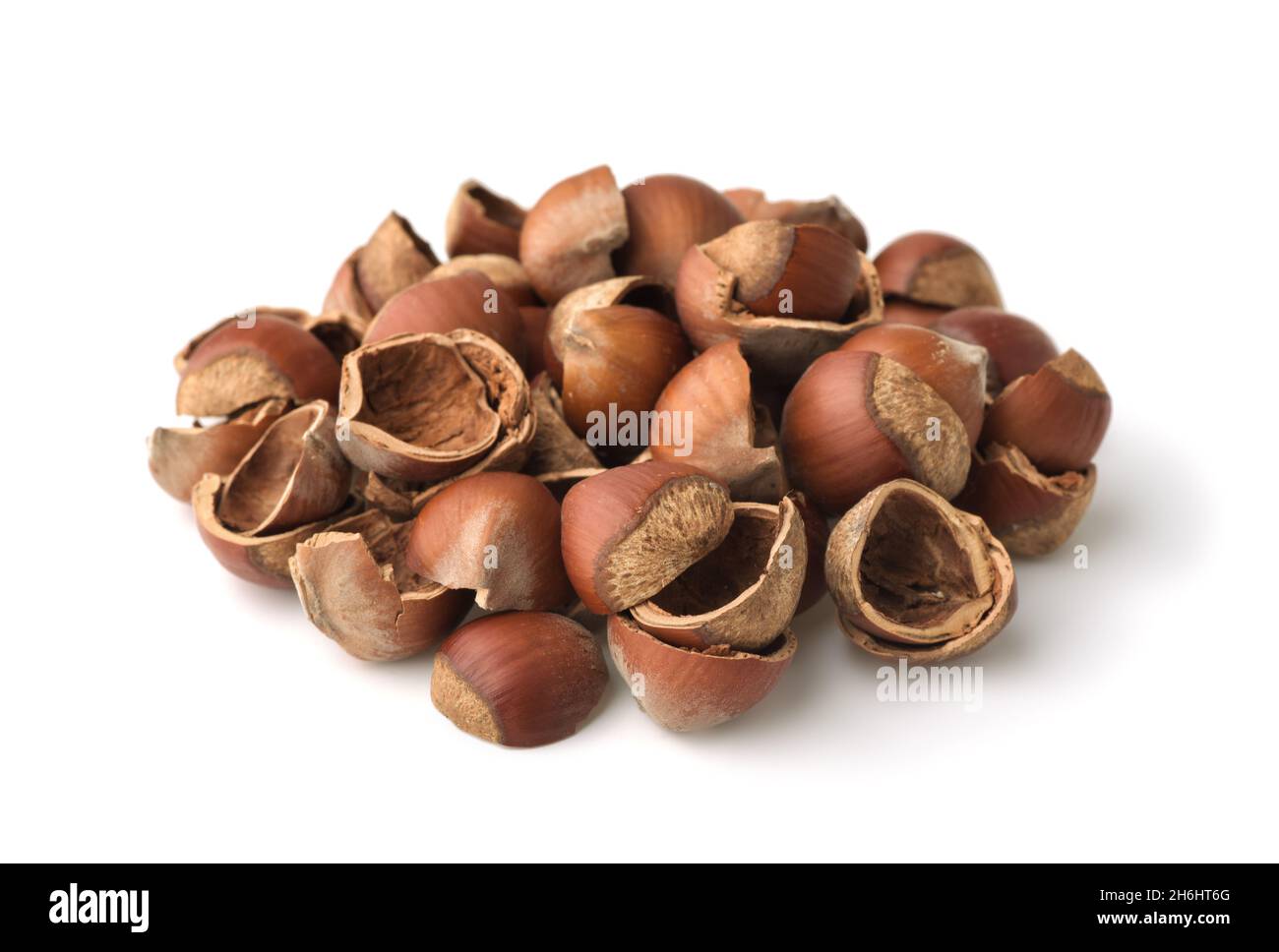 Pile of empty cracked hazelnut shells isolated on white Stock Photo