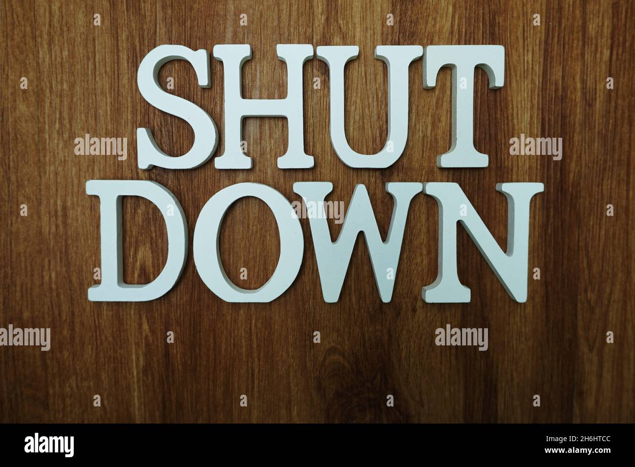 Shut Down Word alphabet letters on wooden background Stock Photo