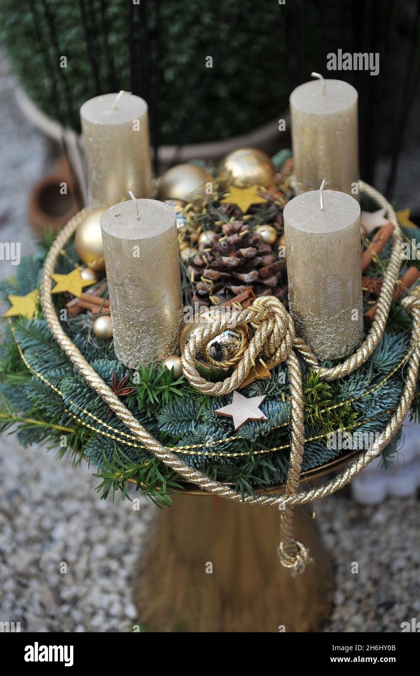 Christmas decoration in interior. An advent wreath with four golden candles Stock Photo