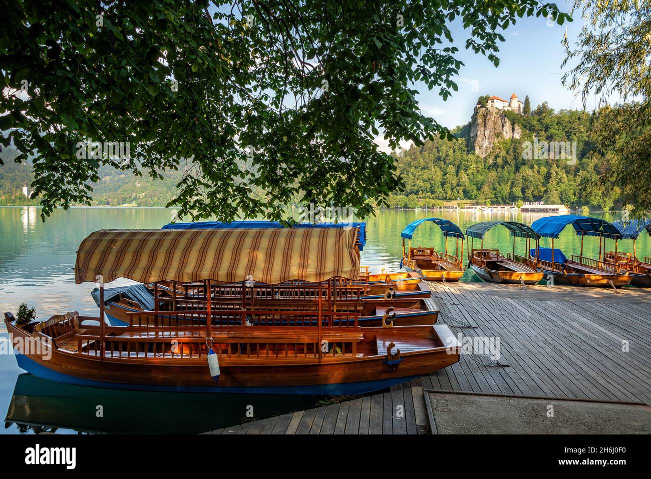 Boats on Lake Bled with Bled Castle in the background Stock Photo