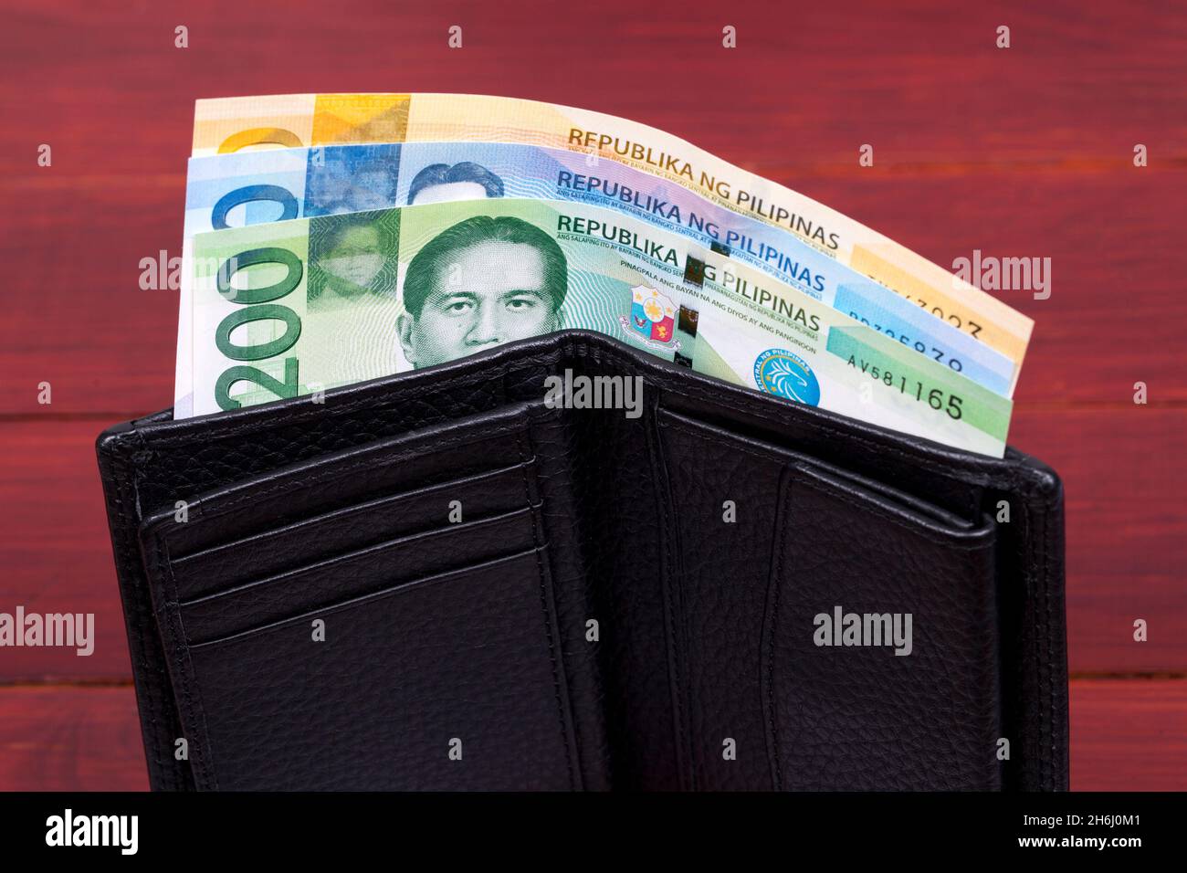 Philippine money - peso in the black wallet Stock Photo - Alamy