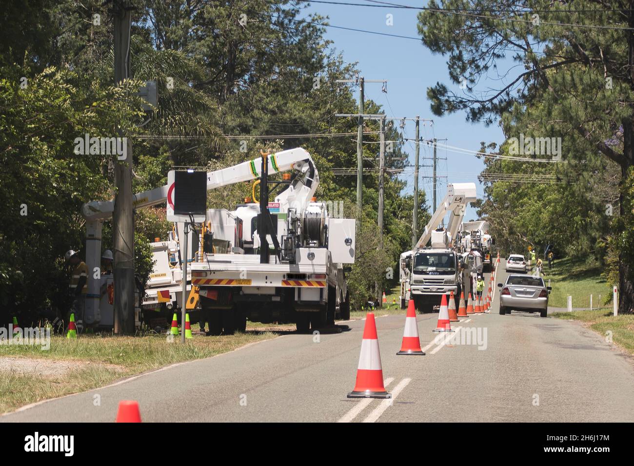 Major works on overhead power supply cables on Tamborine Mountain, Australia. Traffic control, part-road closure, caution, waiting cars, traffic cones. Stock Photo