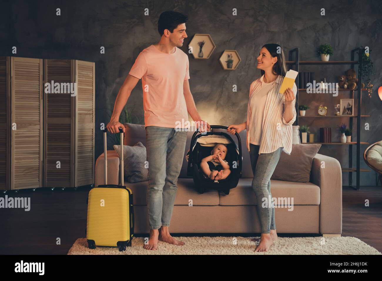 Photo of mom dad daughter baby car seat hold baggage passport covid