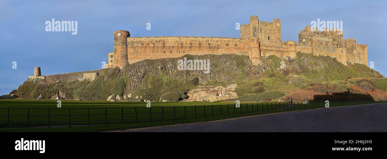 Bamburgh Castle panorama from the west in sunshine Stock Photo