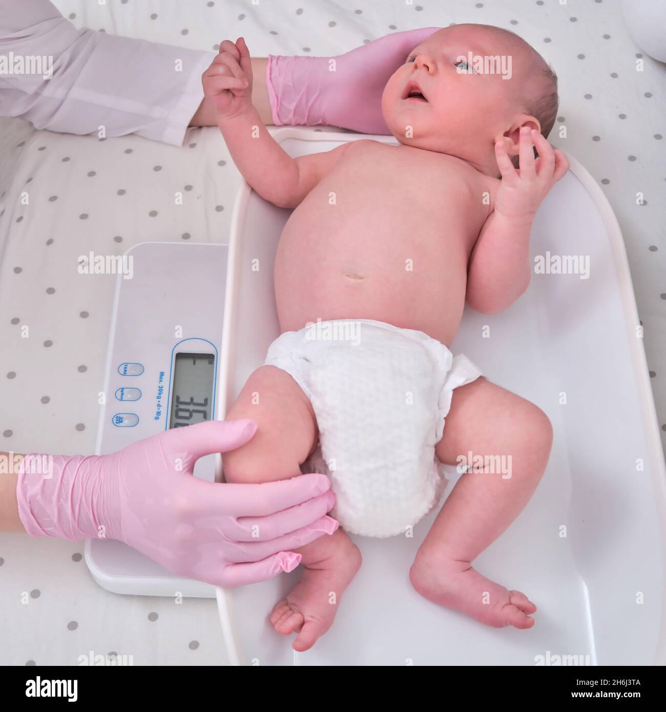 The Doctor Weighs a Newborn Baby on a Scale. Uniformed Nurse Taking  Measurements of the Child Weight Stock Image - Image of illness, pediatric:  230250759