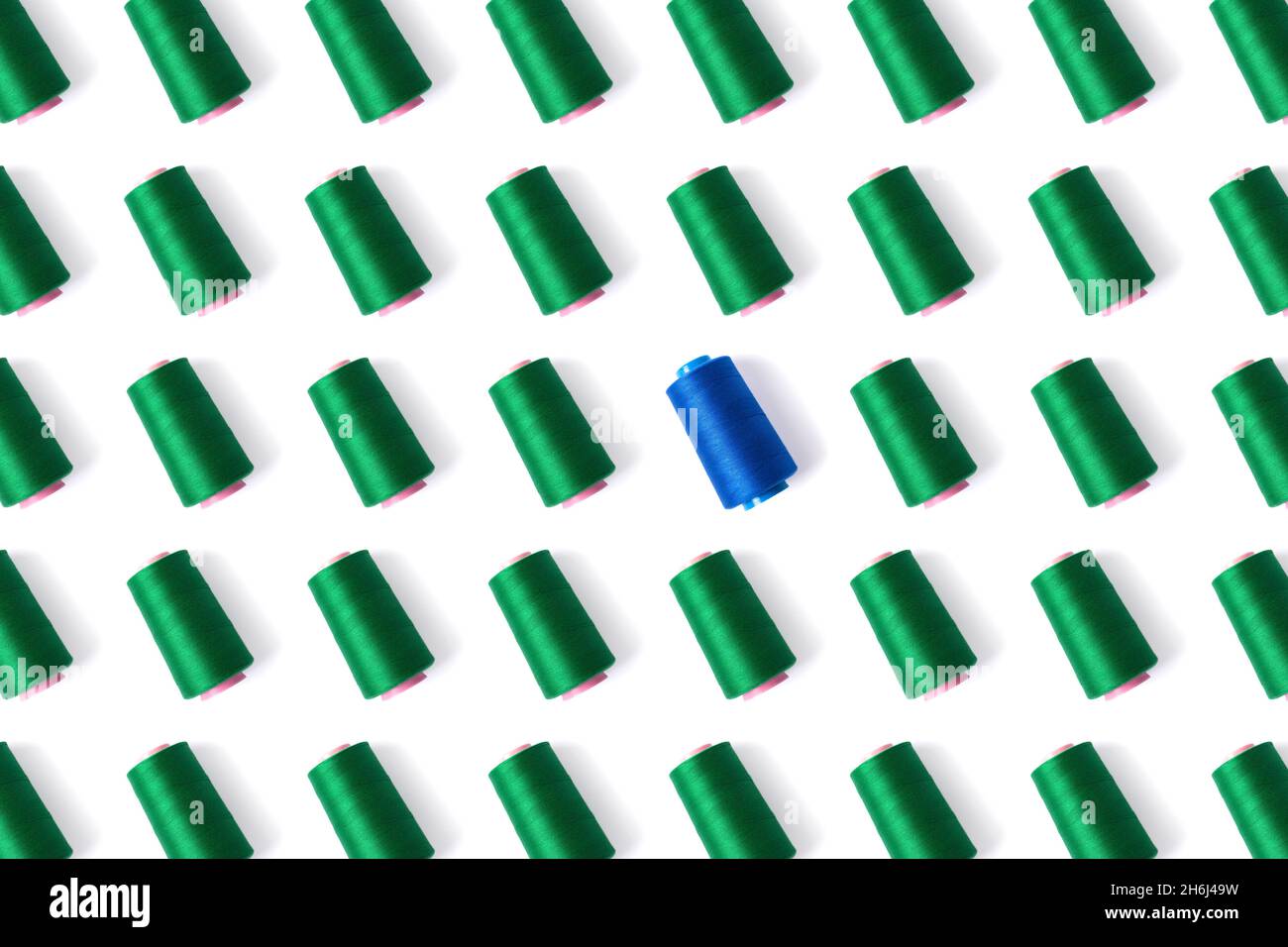 Pattern of spools of sewing thread in green and blue. Stock Photo