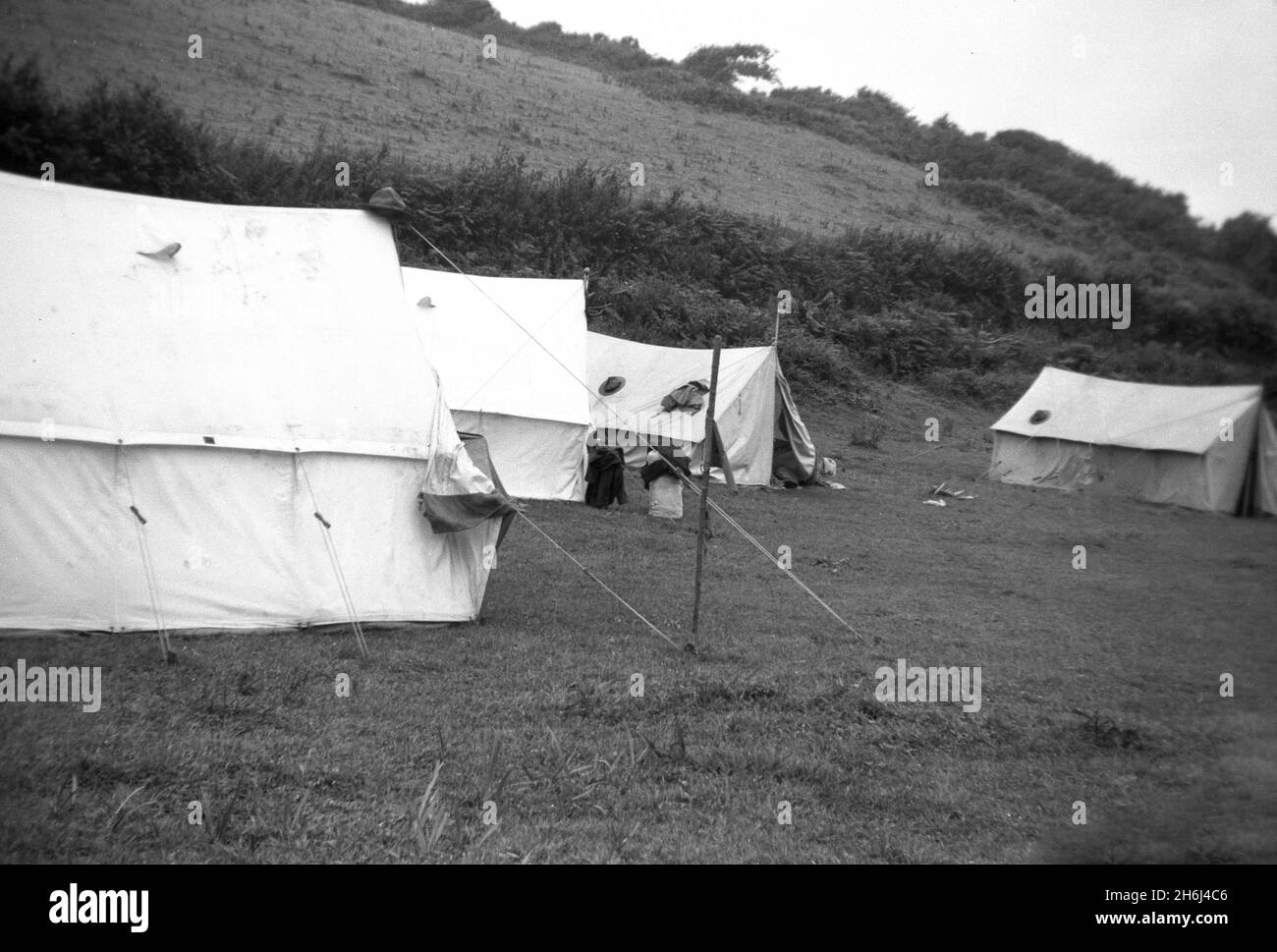 1939, historical, scout camp, traditonal canvasl scouting tents pitched in in a rural field at Ringmore, Devon, England. UK. Stock Photo