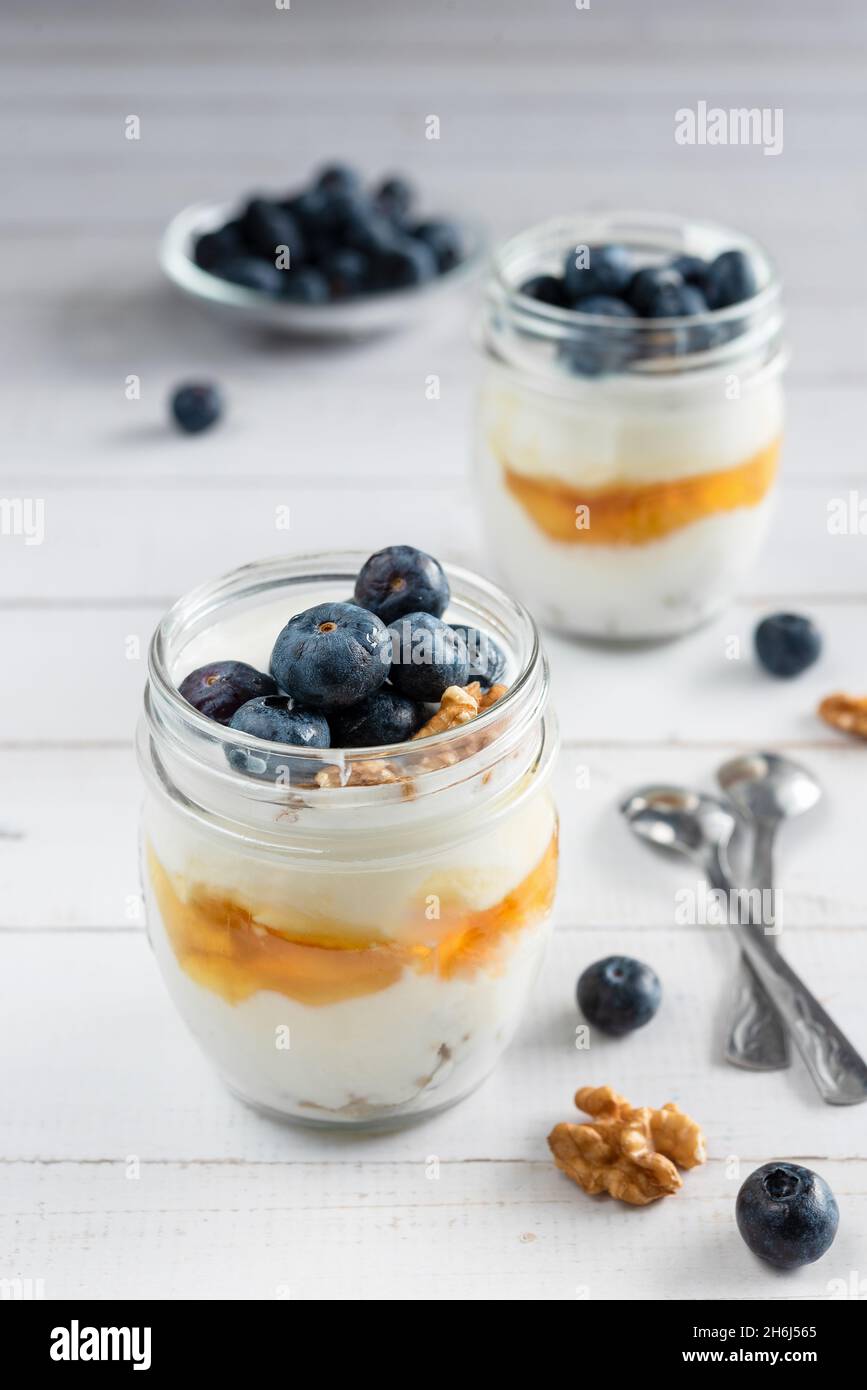 Natural Greek yogurt with fresh blueberries and honey in a jar. Healthy
